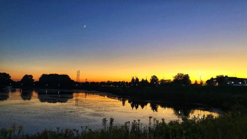 Scenic view of lake against sky during sunset