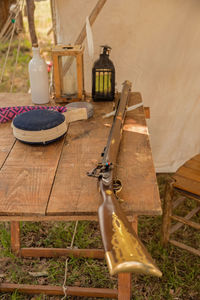 High angle view of old rifle on wooden table