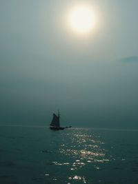 Sailboat sailing on sea against sky