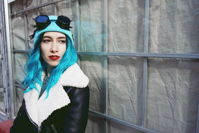 Close-up of fashionable woman with dyed blue hair in city