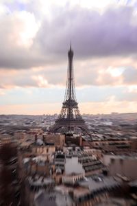 Aerial view of buildings against cloudy sky