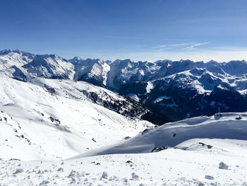 Scenic view of snowcapped mountains against cloudy sky