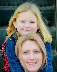 Portrait of smiling woman with daughter