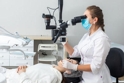 Side view of young man working at clinic