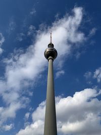 Low angle view of communications tower against sky