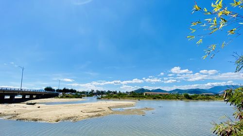 Scenic view of lake against blue sky