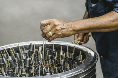 Midsection of man preparing ice cream