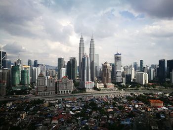 Cityscape against cloudy sky