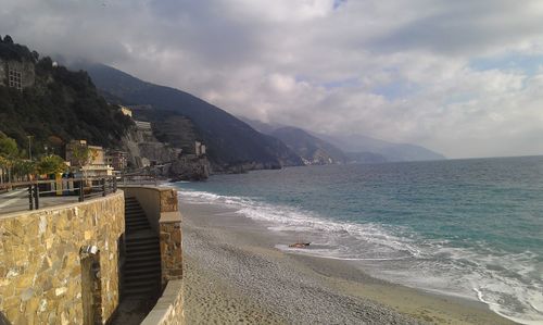 Scenic view of sea and mountains against sky