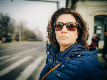 Portrait of man wearing sunglasses standing on street