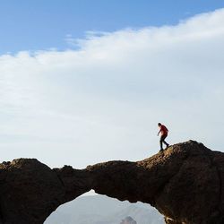 Full length of woman standing on rocks