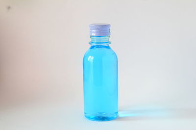 Close-up of blue bottle against white background