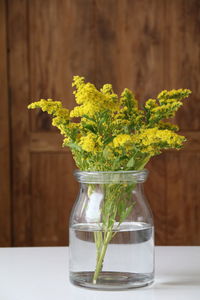 Close-up of vase in glass jar on table