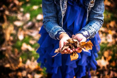 Close-up of hand holding flowers