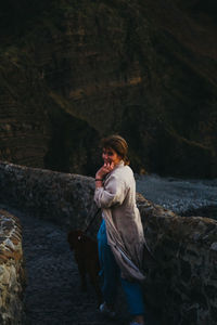 Full length of woman standing on rock