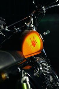 Close-up of bicycle parked on metal at night