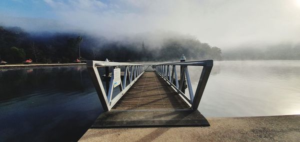 Pier over lake against sky