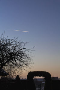 Low angle view of silhouette tree against clear sky