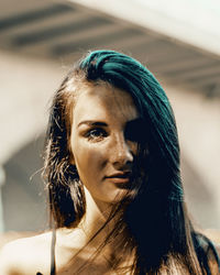 Close-up portrait of young woman standing outdoors