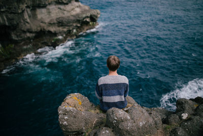 Rear view of man on rock