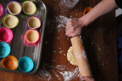 High-angle view of woman's hands preparing muffin dough