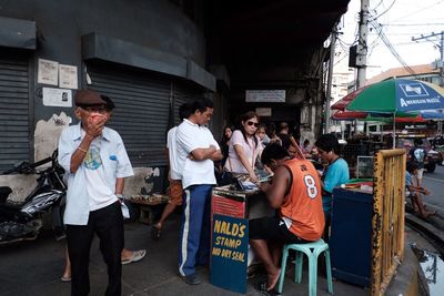 People standing at market stall