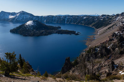 High angle view of crater lake and wizard island against sky
