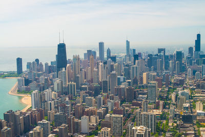 Aerial view of chicago against cloudy sky