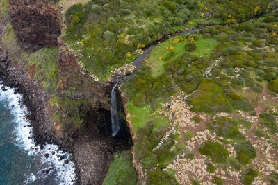 High angle view of stream flowing through rocks