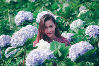 Portrait of smiling woman against plants