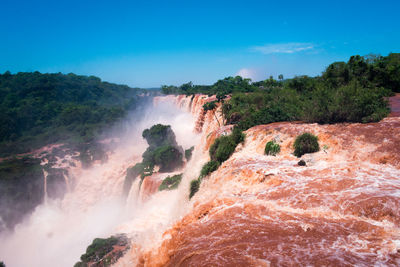 Scenic view of waterfall against sky