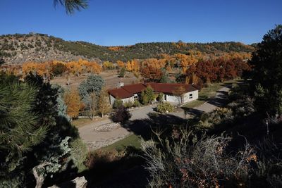 A house in durango, colorado during the fall while trees turn brilliant colors.