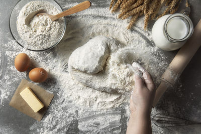 Rustic bread roll or french baguette, wheat and flour on black chalkboard. rural kitchen or bakery 