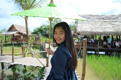 Portrait of smiling young woman standing outdoors