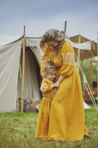 Rear view of woman sitting on tent