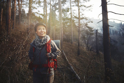 Portrait of man standing in forest