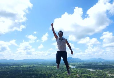 Full length of man standing on mountain against sky