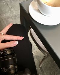 Cropped image of hand holding coffee cup