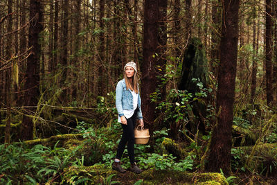 Beautiful woman forages in the rainforest near tofino
