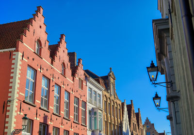 Low angle view of buildings against blue sky