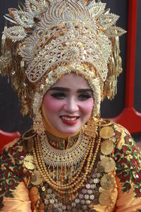 Woman wearing traditional clothing while sitting outdoors