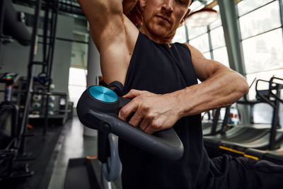 Low section of man exercising in gym