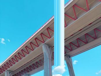 Low angle view of modern highway bridge against clear blue sky