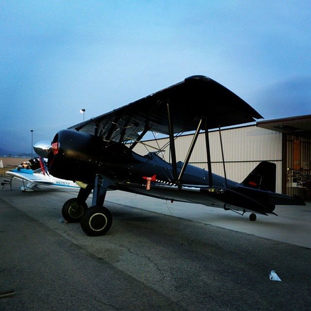 transportation, mode of transport, land vehicle, car, sky, travel, road, on the move, stationary, street, built structure, copy space, architecture, parking, day, blue, outdoors, airplane, journey, airport runway