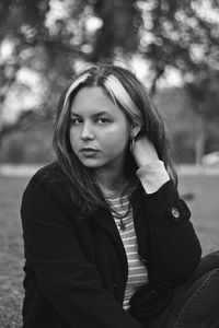 Portrait of woman sitting on field