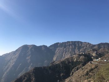 Scenic view of rocky mountains against clear blue sky