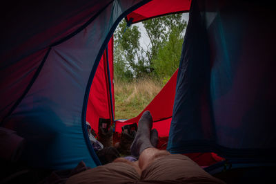 Low section of men relaxing in tent