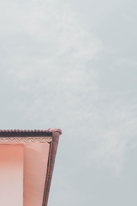 Low angle view of building against cloudy sky