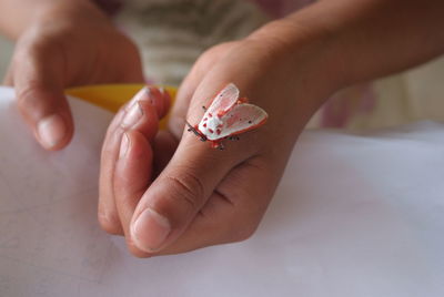 Cropped image of hand holding ring