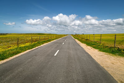 Empty road along countryside landscape